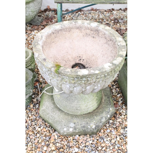 530 - Large reconstituted stone planter with gadrooned decoration, raised on an octagonal stone base (diam... 