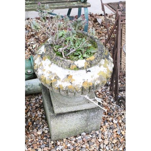 531 - Pair of reconstituted stone garden planters of gadrooned form, raised on square stone plinths (measu... 