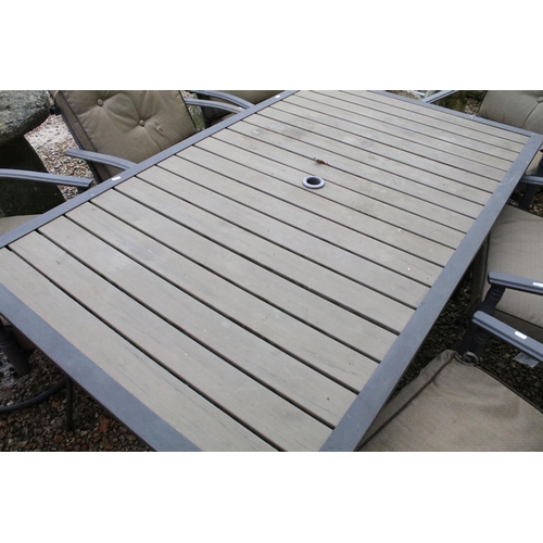 537 - Metal garden patio table with six chairs (featuring two sprung chairs), complete with cushions. (Tab... 