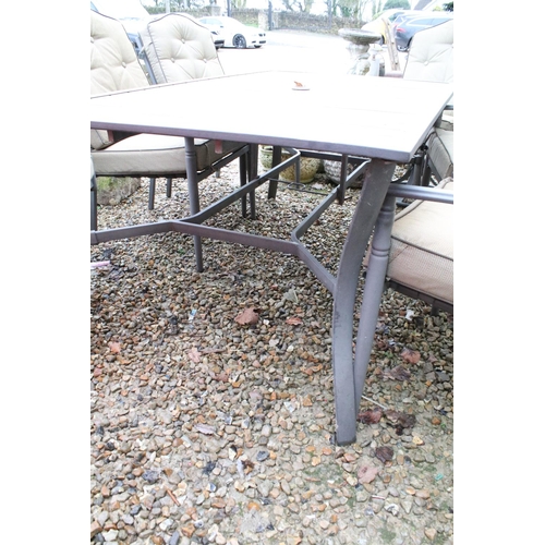 537 - Metal garden patio table with six chairs (featuring two sprung chairs), complete with cushions. (Tab... 