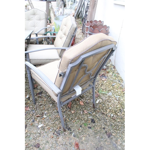 537 - Metal garden patio table with six chairs (featuring two sprung chairs), complete with cushions. (Tab... 