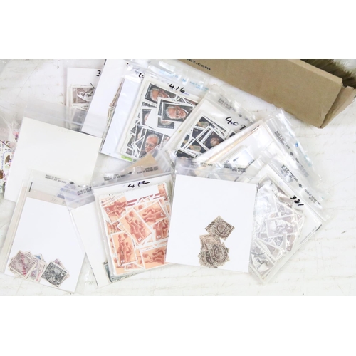 405 - A collection of mixed British and world loose stamps on paper together with a quantity of empty stam... 