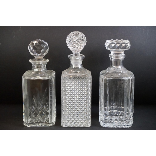 109 - Collection of twelve 20th century glass decanters of varying forms to include a ships decanters, hob... 