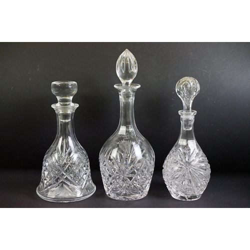 109 - Collection of twelve 20th century glass decanters of varying forms to include a ships decanters, hob... 