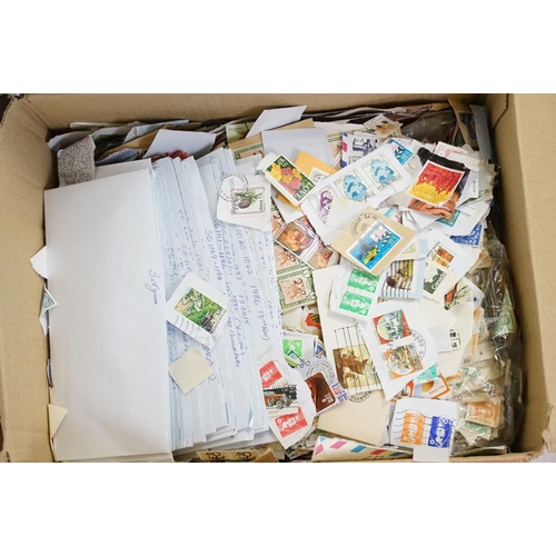 393 - A large collection of used British and world stamps on paper and envelopes, contained within three b... 