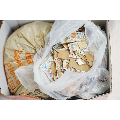 393 - A large collection of used British and world stamps on paper and envelopes, contained within three b... 