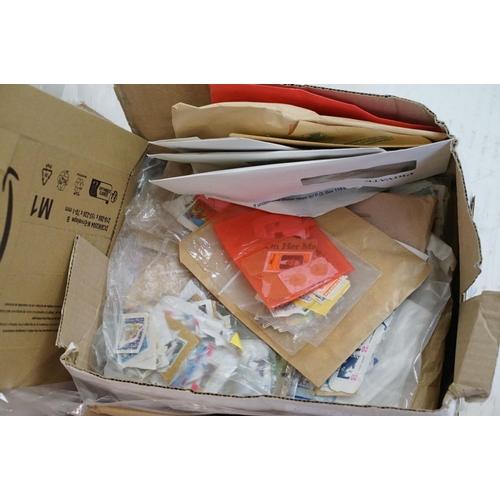 393 - A large collection of used British and world stamps on paper and envelopes, contained within three b... 