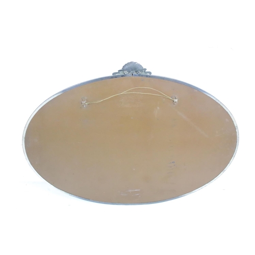 546 - Edwardian oval glass mirror with brass surround together with another mirror, largest 72cm x 53cm