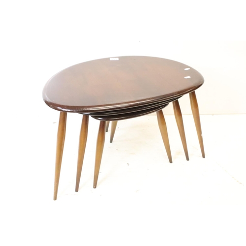 554 - Ercol Nest of Three Dark Elm and Beech Pebble Tables, model no. 354, largest table 41cm high x 65cm ... 