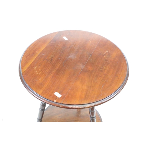 566 - Early 20th century Mahogany Circular Wine or Lamp Table raised on three turned ringed legs united by... 