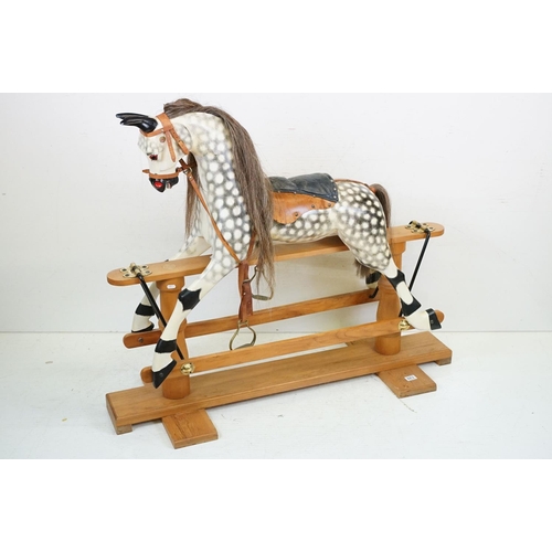 663 - Wooden Painted Dapple Grey Rocking Horse with leather bridle and saddle held on a pine treadle base,... 