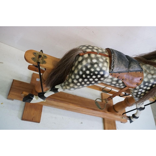 663 - Wooden Painted Dapple Grey Rocking Horse with leather bridle and saddle held on a pine treadle base,... 