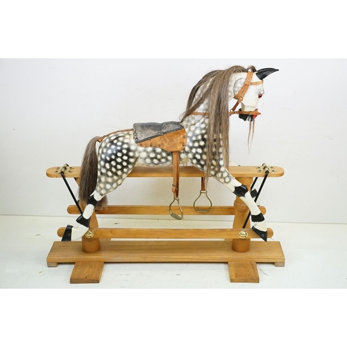 663 - Wooden Painted Dapple Grey Rocking Horse with leather bridle and saddle held on a pine treadle base,... 