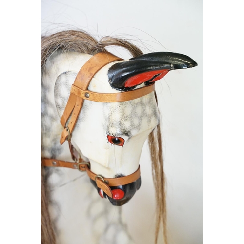 663 - Wooden Painted Dapple Grey Rocking Horse with leather bridle and saddle held on a pine treadle base,... 