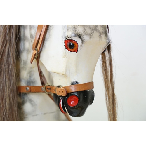 663 - Wooden Painted Dapple Grey Rocking Horse with leather bridle and saddle held on a pine treadle base,... 