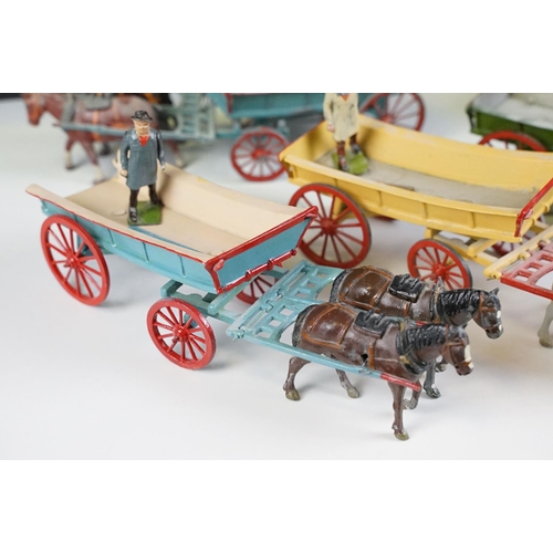 338 - Group of five mid 20th C painted metal Britains horses with carts / farm wagons, each with Britains ... 