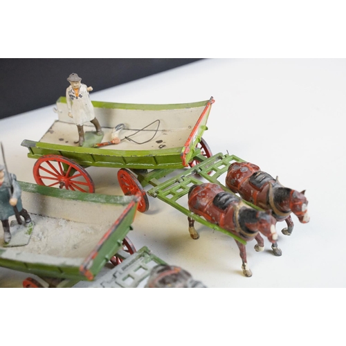 338 - Group of five mid 20th C painted metal Britains horses with carts / farm wagons, each with Britains ... 