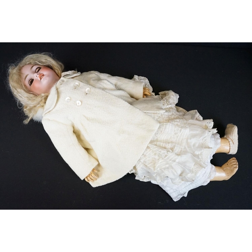 383 - Four early 20th C German bisque headed dolls with glass sleeping eyes, open mouths showing teeth, pa... 