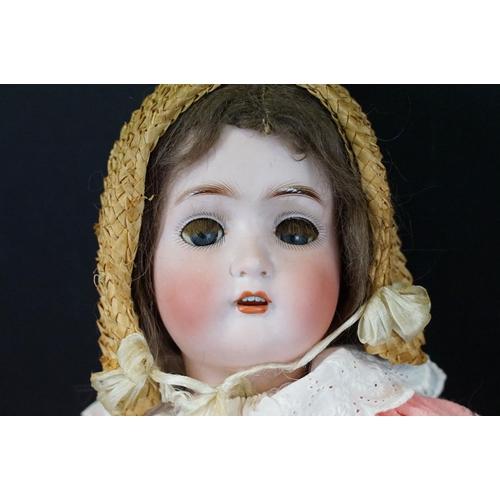 383 - Four early 20th C German bisque headed dolls with glass sleeping eyes, open mouths showing teeth, pa... 