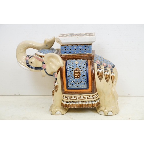 42 - Pair of Chinese ceramic elephant stools modelled with trunks aloft, with blue, pink & brown glazed d... 