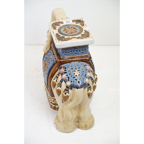 42 - Pair of Chinese ceramic elephant stools modelled with trunks aloft, with blue, pink & brown glazed d... 