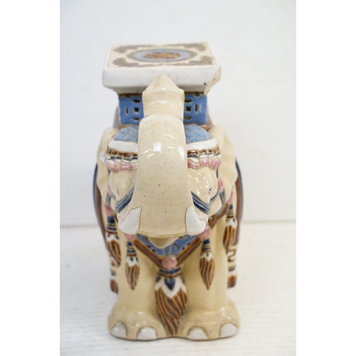 42 - Pair of Chinese ceramic elephant stools modelled with trunks aloft, with blue, pink & brown glazed d... 