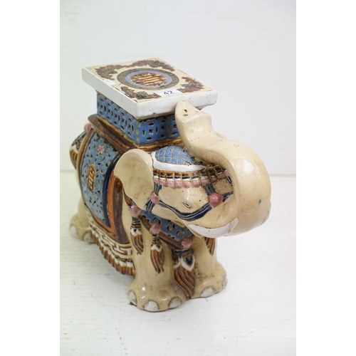 42 - Pair of Chinese ceramic elephant stools modelled with trunks aloft, with blue, pink & brown glazed d... 