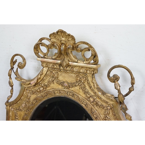 551 - Antique Giltwood and Gesso Framed Shaped Mirror in the Rococo style with oval bevelled plate, 95cm x... 