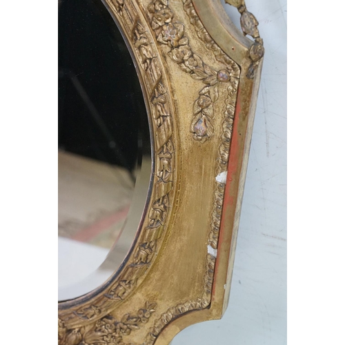 551 - Antique Giltwood and Gesso Framed Shaped Mirror in the Rococo style with oval bevelled plate, 95cm x... 