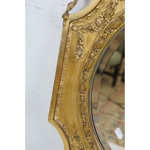 551 - Antique Giltwood and Gesso Framed Shaped Mirror in the Rococo style with oval bevelled plate, 95cm x... 