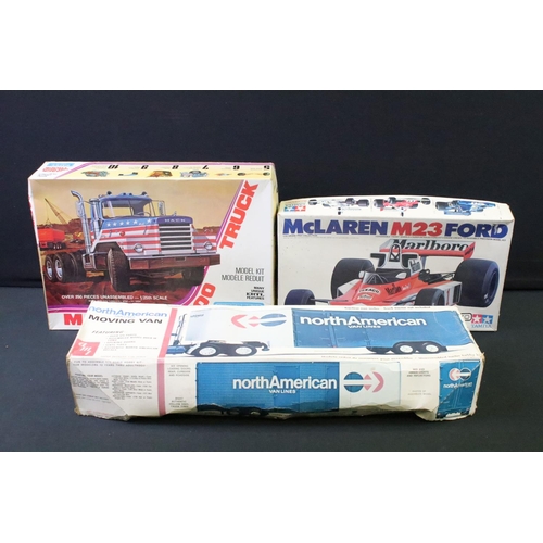 197 - Three boxed plastic model kits to include Tamiya 1/20 GC2002 McLaren M23, ertl 1/25 Mack DM800 Truck... 