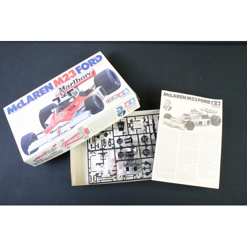 197 - Three boxed plastic model kits to include Tamiya 1/20 GC2002 McLaren M23, ertl 1/25 Mack DM800 Truck... 