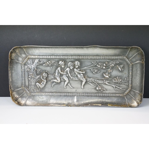 114 - Helmuth Schievelkamp for WMF (1849-1932) - A plated metal tray with repousse decoration of children ... 