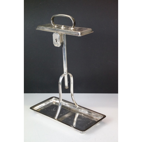 120 - Early-to-mid 20th C silver plated tantalus with rectangular base and carry handle, housing two cut g... 