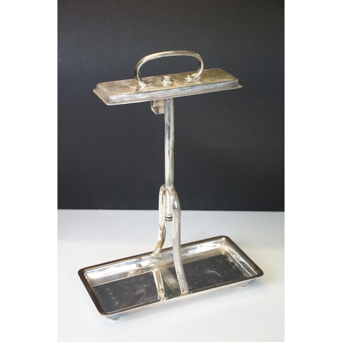 120 - Early-to-mid 20th C silver plated tantalus with rectangular base and carry handle, housing two cut g... 