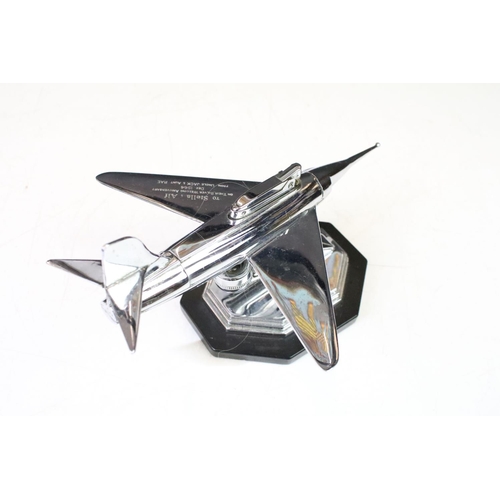 134 - Mid Century 1960s chrome plated table lighter in the form of a plane raised on a stepped hexagonal b... 