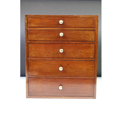 146 - Mahogany desk top set of drawers having a bank of five drawers with brass knob handles. Measures 27.... 