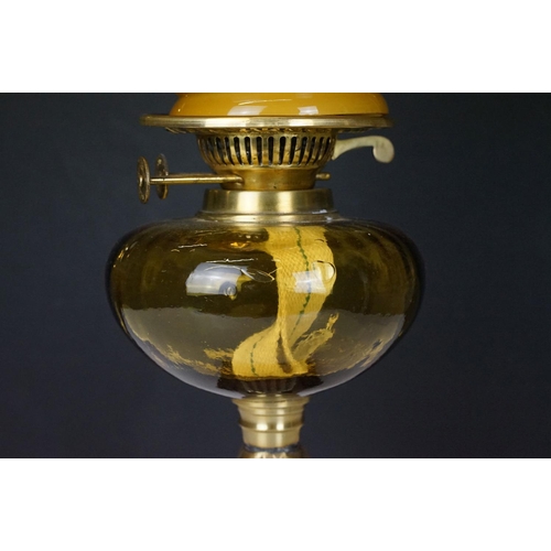 166 - 19th Century Victorian oil lamp having a cast brass base with moulded roses, amber glass reservoir a... 