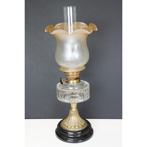 167 - 19th Century Victorian oil lamp having a round fluted brass base, faceted clear glass reservoir, and... 