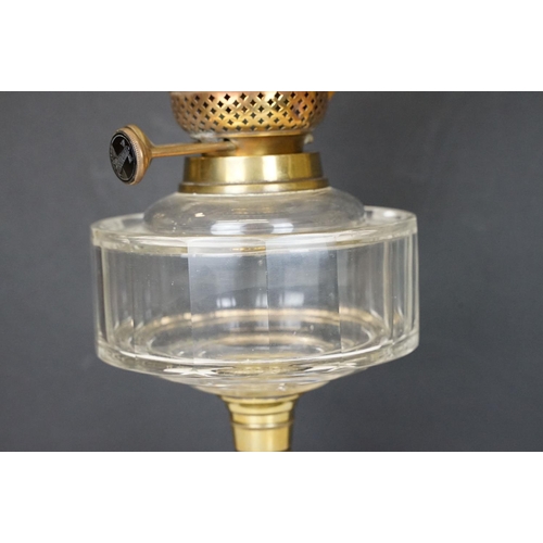 167 - 19th Century Victorian oil lamp having a round fluted brass base, faceted clear glass reservoir, and... 