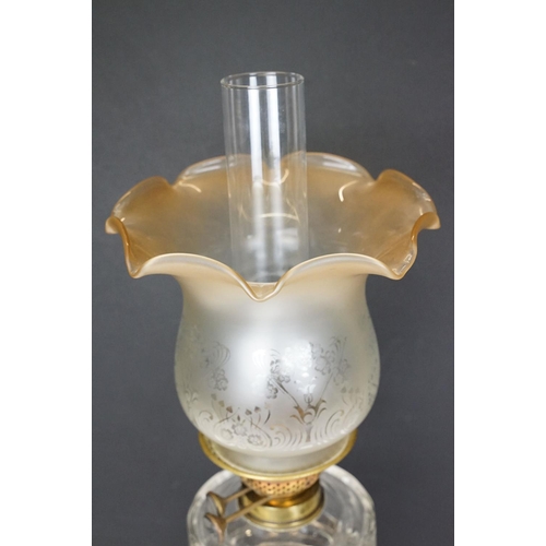 167 - 19th Century Victorian oil lamp having a round fluted brass base, faceted clear glass reservoir, and... 