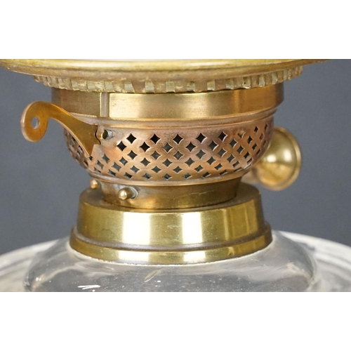 167 - 19th Century Victorian oil lamp having a round fluted brass base, faceted clear glass reservoir, and... 