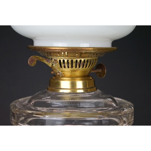 168 - 19th Century Victorian oil lamp having a fluted brass base, faceted glass reservoir, with fanned rim... 