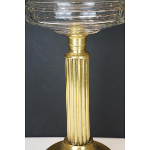 168 - 19th Century Victorian oil lamp having a fluted brass base, faceted glass reservoir, with fanned rim... 