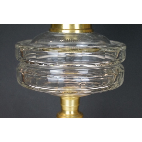 168 - 19th Century Victorian oil lamp having a fluted brass base, faceted glass reservoir, with fanned rim... 