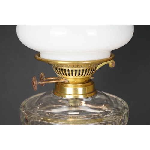 168 - 19th Century Victorian oil lamp having a fluted brass base, faceted glass reservoir, with fanned rim... 