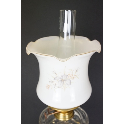 168 - 19th Century Victorian oil lamp having a fluted brass base, faceted glass reservoir, with fanned rim... 