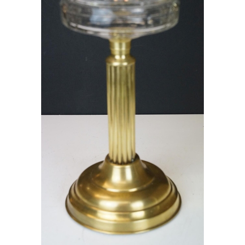 168 - 19th Century Victorian oil lamp having a fluted brass base, faceted glass reservoir, with fanned rim... 