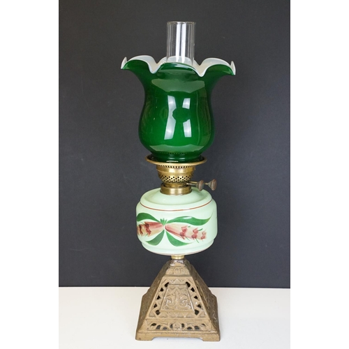 171 - Late Victorian / early 20th Century oil lamp having a cast metal base, green glass reservoir with ha... 