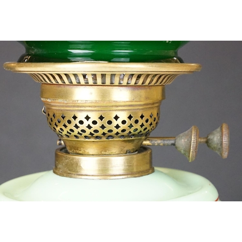 171 - Late Victorian / early 20th Century oil lamp having a cast metal base, green glass reservoir with ha... 